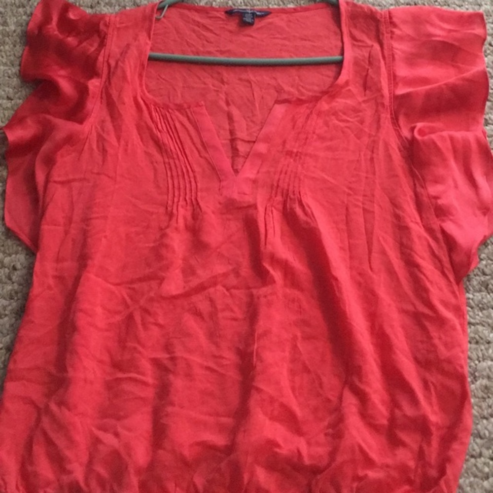 Coral, light weight shirt with ruffle sleeves.